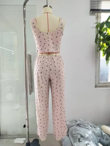 Detail view of pink floral pajama set with V-neck sleeveless top and long trousers on mannequin