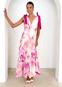 Detail of pink floral V-neck maxi dress featuring large magenta bow shoulder straps