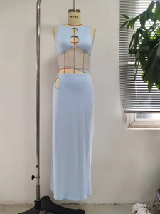 Detail view of light blue bodycon dress with white floral lace and waist cutout design