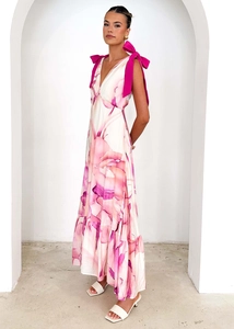 Detail of V-neck sleeveless dress featuring large pink shoulder bows and floral print