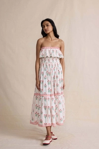 Detail of white strapless maxi dress with floral print and red ruffled edges