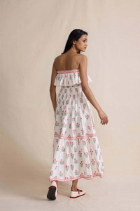 Detailed back view of white floral maxi dress with red woven trim and elastic waist