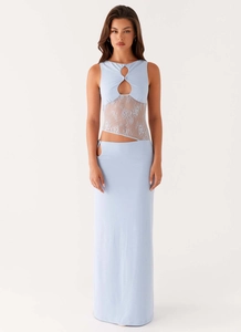 Detail of light blue two-piece set featuring lace patchwork and chic cutout design