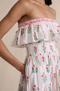 Close-up of smocked waist detail and floral print on a strapless bohemian dress