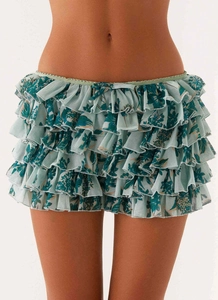 Detail of light green multi-layer ruffled skort with dark green tropical floral print
