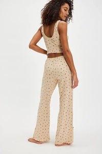 Detail view of floral loungewear set showing yellow trim and high-waist wide-leg pants