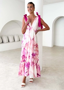 Detail of pink marble print dress with V-neck and fuchsia ribbon bow shoulder straps