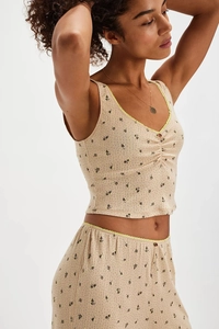 Detail of floral V-neck camisole with neon lace trim and ribbed knit fabric texture
