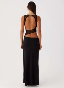 Detail view of the backless cutout and lace stitching on the black slim-fit dress