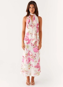 Detail of pink floral halter dress showing V-neckline and elegant silky fabric texture