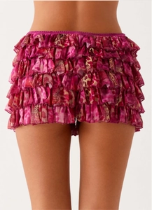Detail view of pink leopard print tiered ruffles on stylish layered skirt shorts