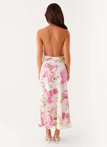 Detail of backless halter dress showing pink floral print and elegant tie-up back design