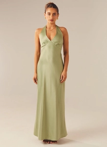 Detail of sage green satin maxi dress with deep V-neck and ruched waistline on studio model