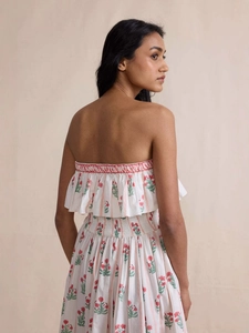Elegant floral strapless dress with smocked waist and ruffles in ivory and pink