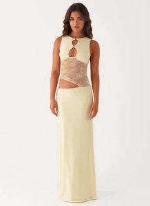 Detail of cream sleeveless dress featuring waist cut-out and delicate lace patchwork