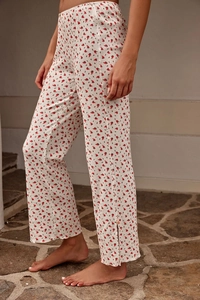 Detail of floral lounge pants showing knit texture and side slit with button accent