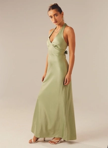 Detail of sage green satin halter dress featuring elegant crossover V-neck and open back