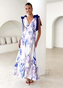 Detail of V-neck white maxi dress with blue floral print and shoulder ribbon bows