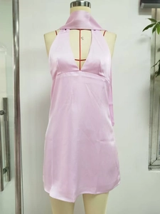 Detail of light pink satin halter mini dress with deep V-neck on a mannequin