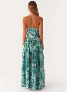 Detail view of the back of a blue bohemian strapless maxi dress with floral leaf patterns