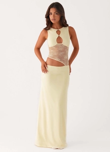 Detail of light yellow slim dress featuring lace panels and teardrop chest cutouts