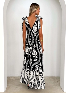Detail of deep V-back design with bow straps and black and white floral print