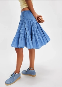 Detail of blue tiered skirt featuring elastic waistband with tassel drawstring closure
