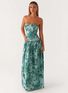 Detail of bohemian strapless maxi dress featuring teal floral print on light blue fabric