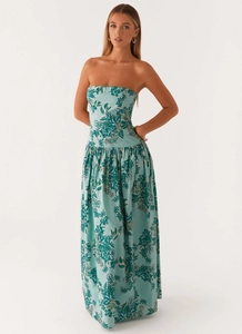 Close-up of bohemian strapless maxi dress with floral print and light blue fabric