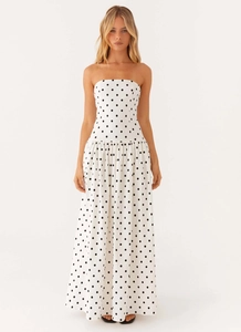 Detail view of strapless maxi dress with black polka dots and flowing A-line silhouette