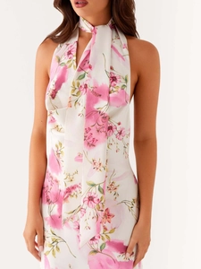 Sleeveless halter neck dress with pink floral print and elegant draped neckline