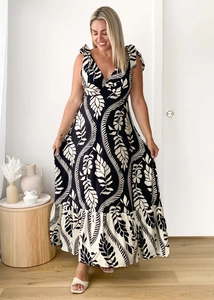 Detail of V-neck sleeveless maxi dress with black and white tropical leaf print and tie straps