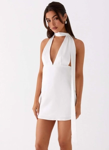Detailed view of white satin halter dress with V-neckline and long draped neck tie