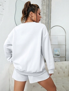 Rear view of white loose-fit sweatshirt and shorts set with heart print details