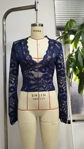 Détail du haut en dentelle bleu marine à col en V avec motifs floraux et coupe ajustée