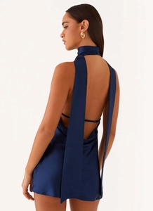 Detail of navy blue backless satin mini dress with elegant hanging scarf neck straps
