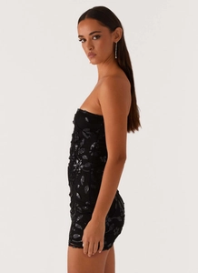 Detail of elegant black sequin and floral embroidery on a strapless bodycon mini dress