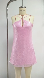 Macro detail of pink sequin dress showing halter neck design and hollow out neckline