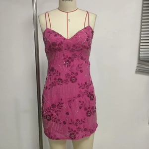 Macro detail of Fuchsia sleeveless dress featuring floral embroidery and sequins