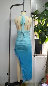 Detailed back view of light blue ruched halter dress with side ruffle and asymmetrical hem