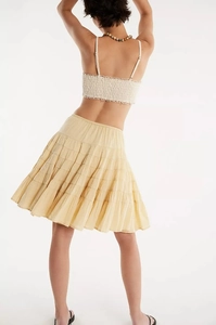 Detail view of the layered tier design on a light yellow summer tiered maxi skirt