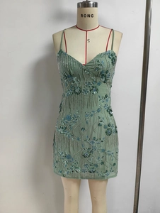 Detailed view of green strap dress with beaded floral embroidery and sequins