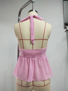 Detail of pink halter neck top showing elasticated back and ruffled hemline