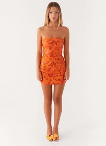Close-up of orange strapless mini dress featuring intricate floral embroidery and sequins