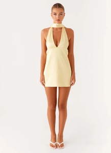 Detail of light yellow satin mini dress with deep V-neck and halter neck design