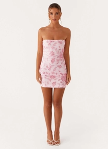 Close-up of pink strapless mini dress featuring intricate floral embroidery and sequins