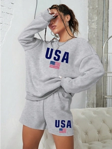 Detail of grey crewneck sweatshirt and shorts set with blue USA letters and flag print