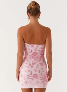 Close-up of pink sequined floral embroidery on the back of a slim mini tube dress