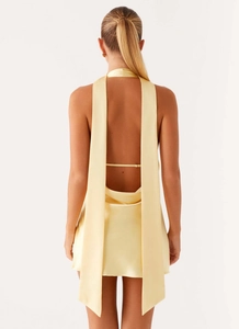 Close-up of backless satin mini dress with delicate straps and a low-cut open back