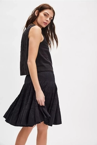 Detailed back view of a black tiered mini skirt and sleeveless top with floral embroidery